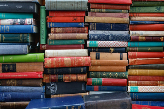 Pile of books. Photo by Ed Robertson on Unsplash [https://unsplash.com/@eddrobertson] 