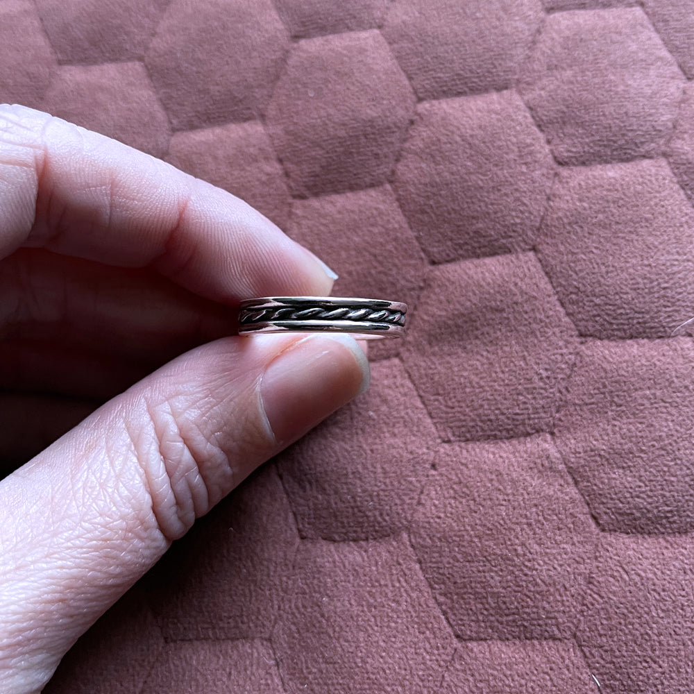 Fingers holding beau ring