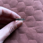 Fingers holding beau ring