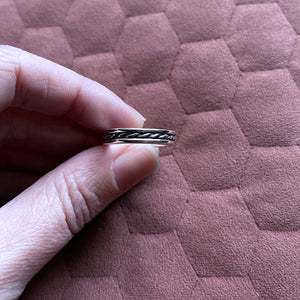 Fingers holding beau ring