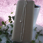 Heart shaped chain connected together, displayed vertically on cushion