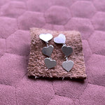 Close up juliet 2 heart drop earrings on leather square