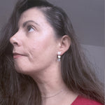 Side portrait of Elise wearing juliet earrings