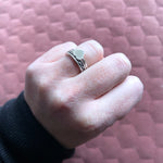 Vida heart ring and beau ring stacked together on ring finger of hand in a fist 