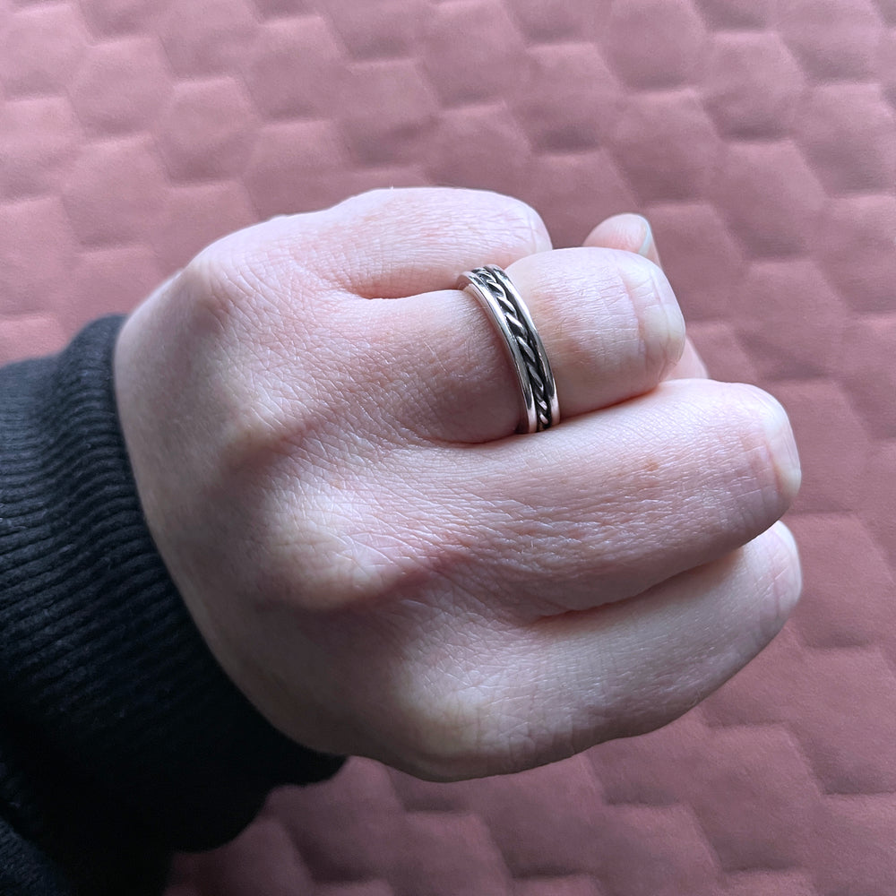 Hand in fist showing beau ring on ring finger