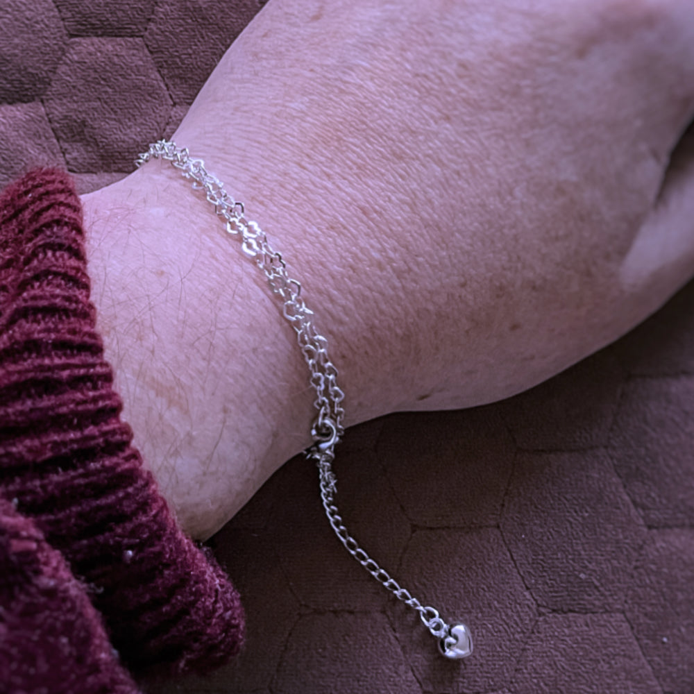 Heart chain wrapped around wrist to create a bracelet