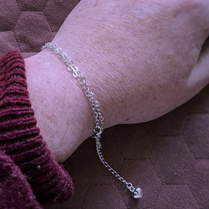 Heart chain wrapped around wrist to create a bracelet