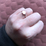 Hand in fist showing vida heart ring on ring finger