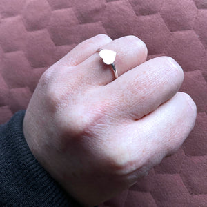 Hand in fist showing vida heart ring on ring finger